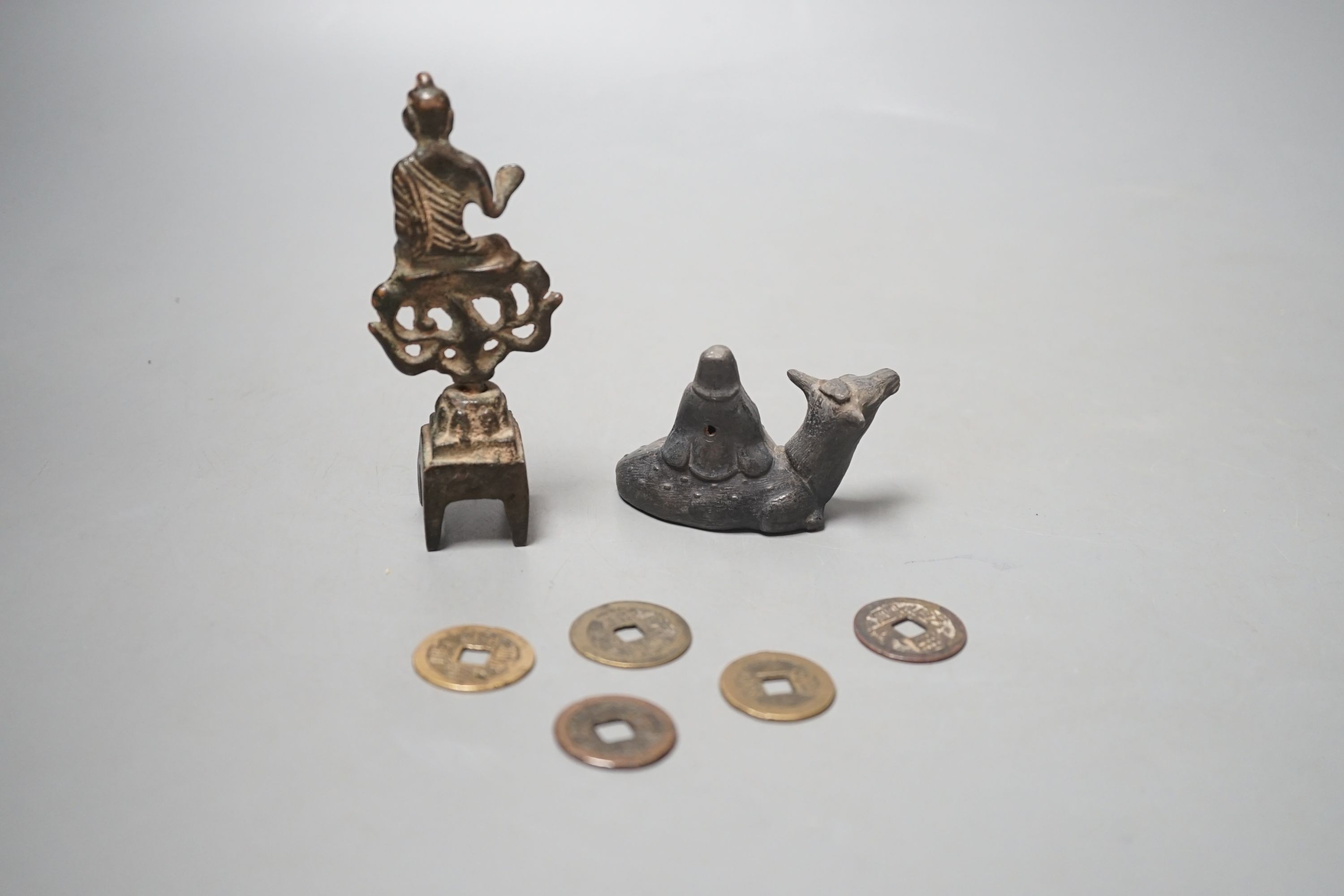 A collection of Chinese coins, together with a water dipper in the form is a seated animal, and a seated Buddha (7)